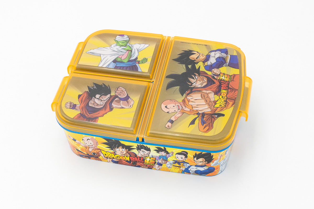 Fiambrera escolar amarilla de Dragon Ball Super con tres compartimentos y personajes de anime en las tapas.