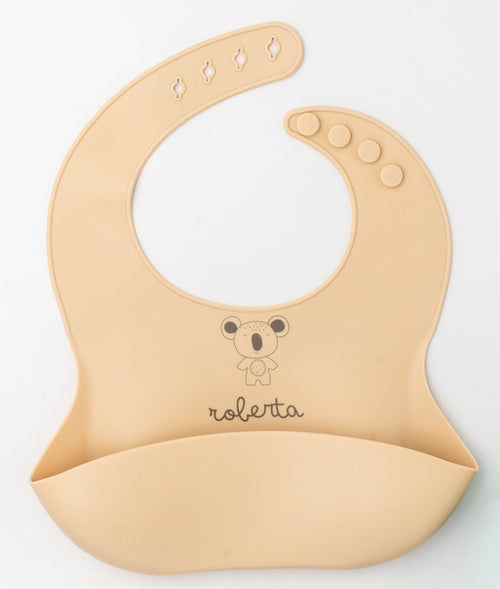 Babete de silicone pêssego claro com o nome Roberta e um coala gravados