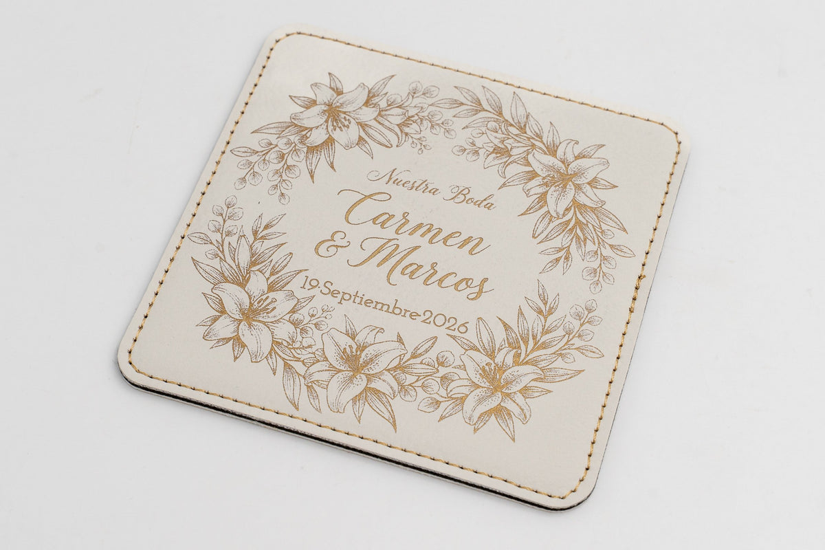 Base para copos quadrada branca com moldura floral e nomes em tom dourado.